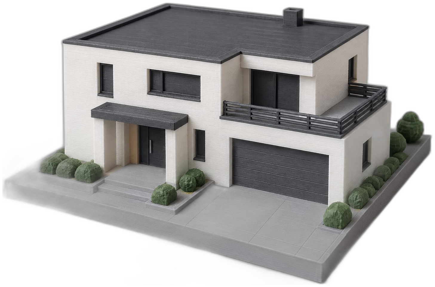 3D-printed model of a modern villa: white façade, anthracite flat roof, garage and green shrubs on a grey base plate